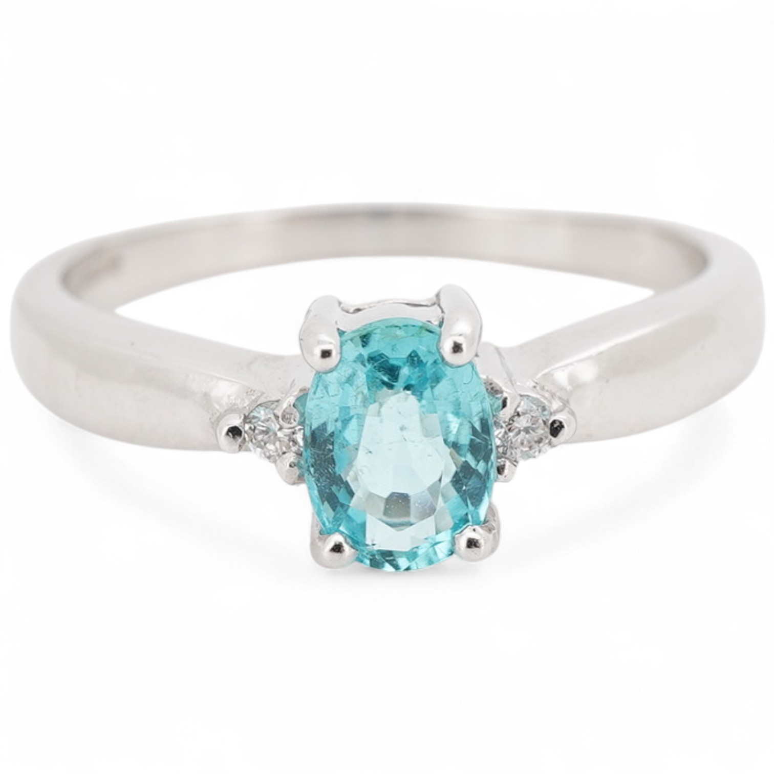 A Paraiba-type tourmaline and diamond ring, claw-set with an oval light blue tourmaline measuring approximately 6.1 x 4.6 x 3mm and weighing approximately 0.40 carats, between brilliant-cut diamonds totalling approximate